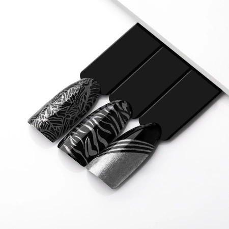 Hand holding nail art brushes