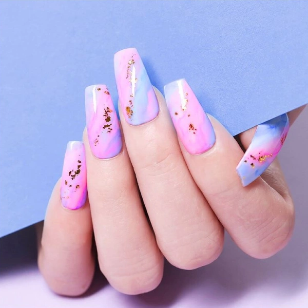 Pastel wash aura nails with a pink and blue blend, gold foil and a ballerina shape