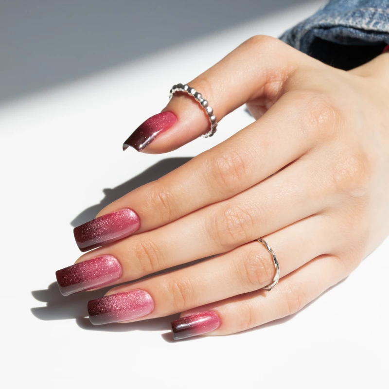 Long square cat-eye ombré nails in shades of pink and burgundy