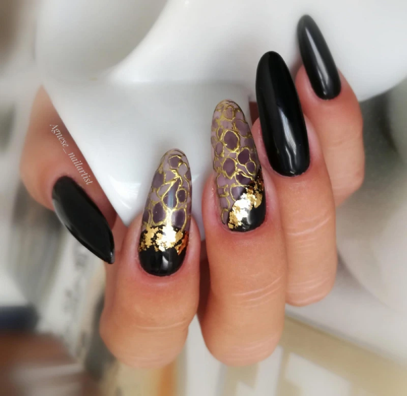 Black almond nails with gold crackle effect and gold foil
