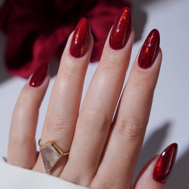 Red nails with shimmering particles