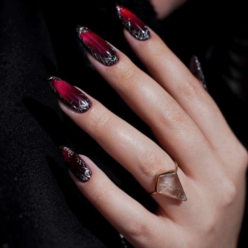 Red and black cat eye nails with metallic silver details