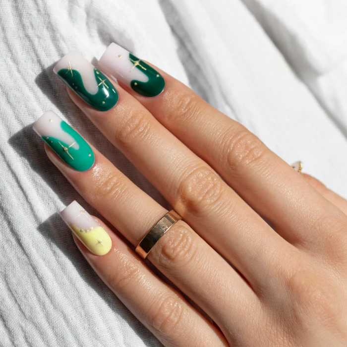 Long square nails with green abstract nail art and gold lines
