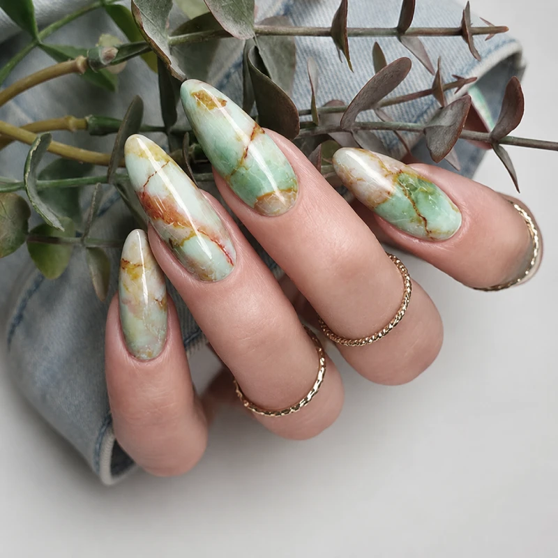 Long almond nails with a green onyx marble effect