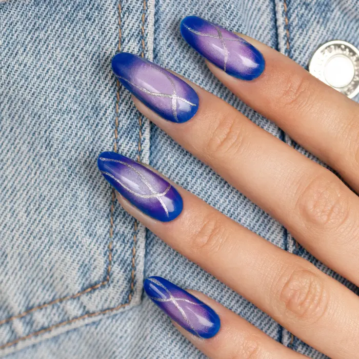 Blue and purple ombre nails with silver lines and a matte finish