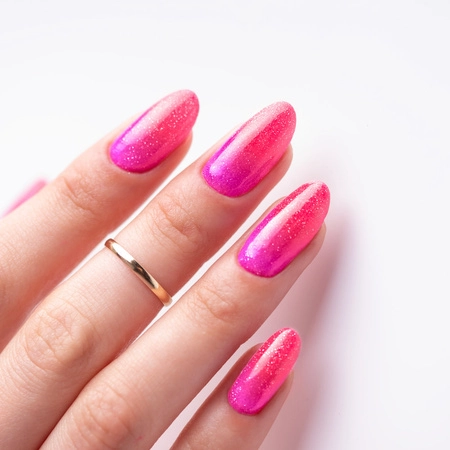 Pink ombré gel nails finished with Molly Nails Flash Top Coat