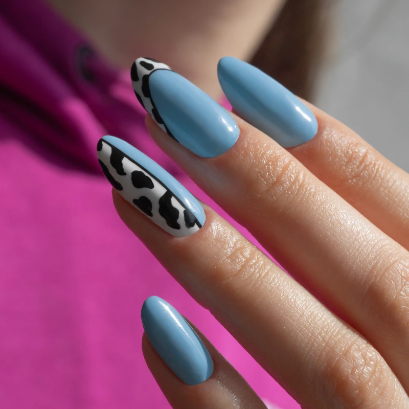 Tiffany blue almond nails with a cow print design