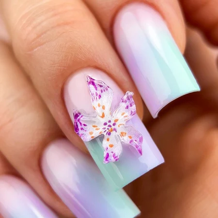 Summer manicure with a blue and purple 3D floral design