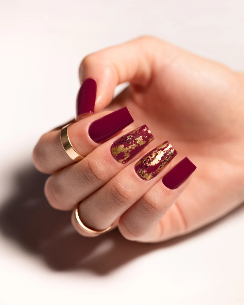 Cherry red manicure with gold foil nail art using MollyNails Cherry Bomb 302